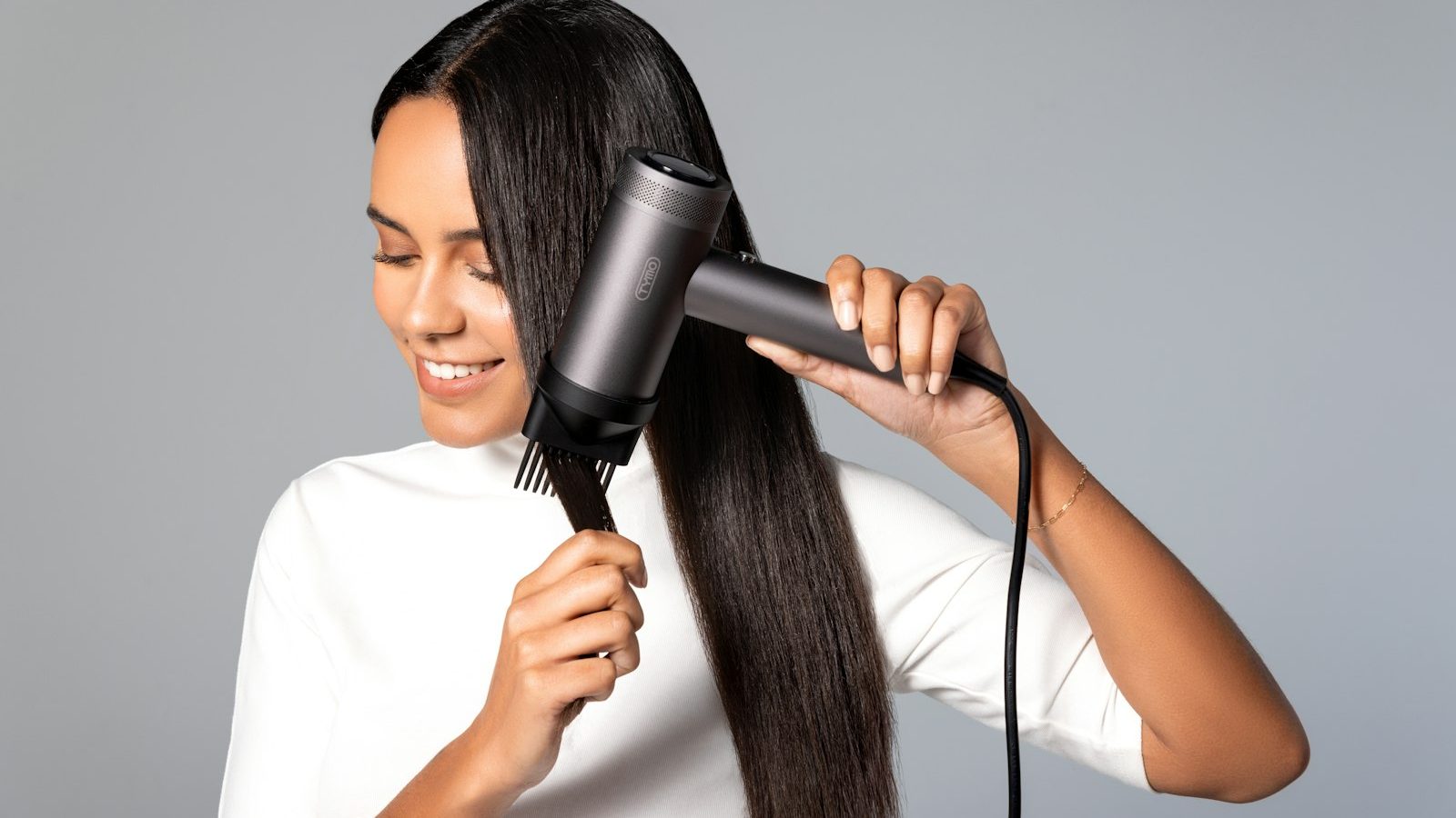 Hair stylist: woman blow-drying long straight hair