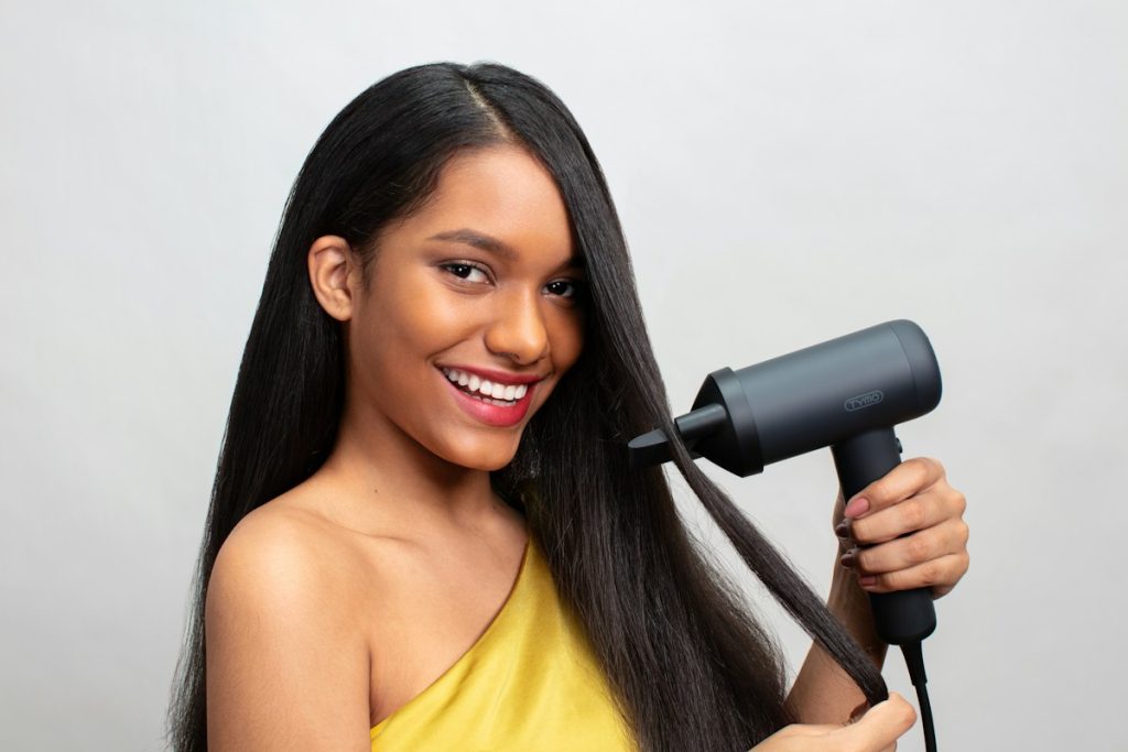 Hair stylist: smiling woman styling long sleek hair