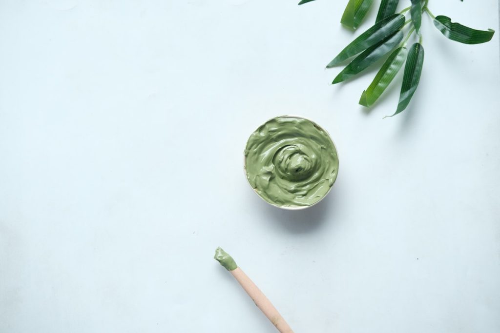 Gold facial good for skin: green clay mask in a small bowl
