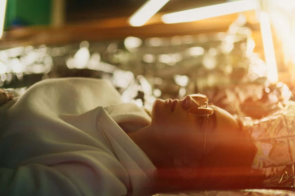 Beauty salon near me within 400m: woman resting on a spa bed in warm light