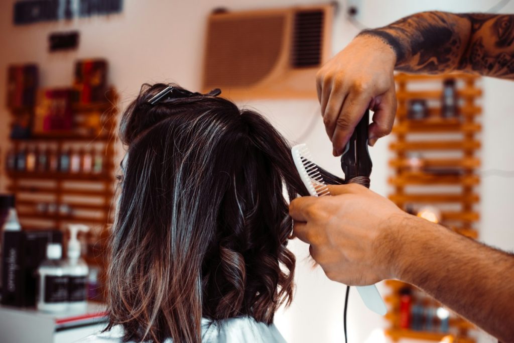 Ladies salon open now: stylist cutting a client's shoulder-length hair