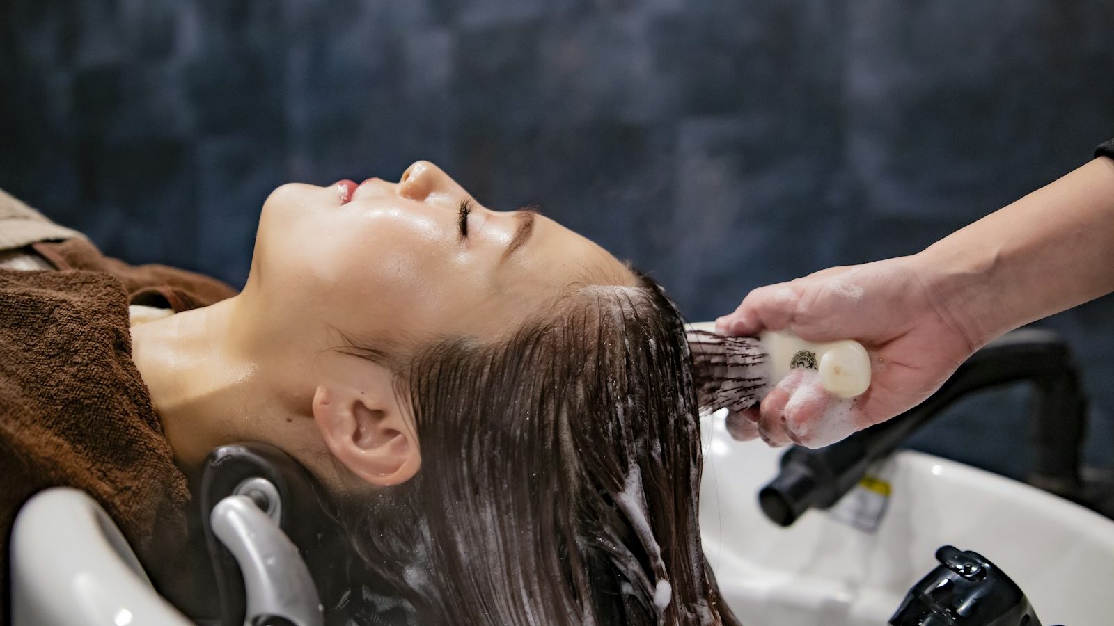 Spa near me within 400m: stylist brushing wet hair at the wash basin