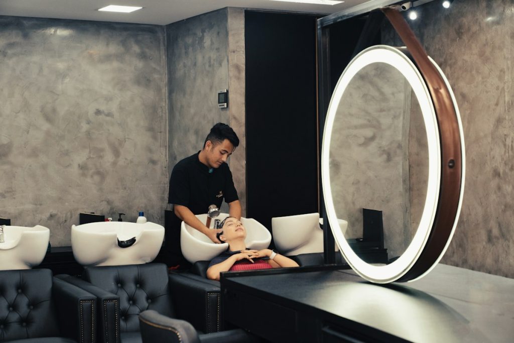 Spa near me within 400m: spa wash area with a backlit round mirror