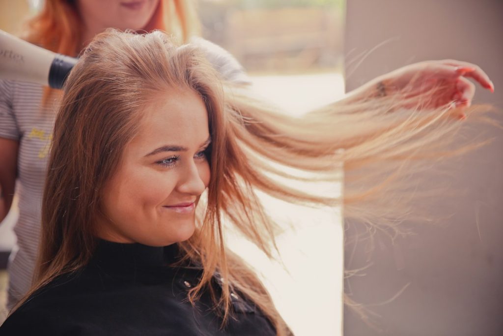 Beauty salon in Majan: happy client with freshly styled flowing hair