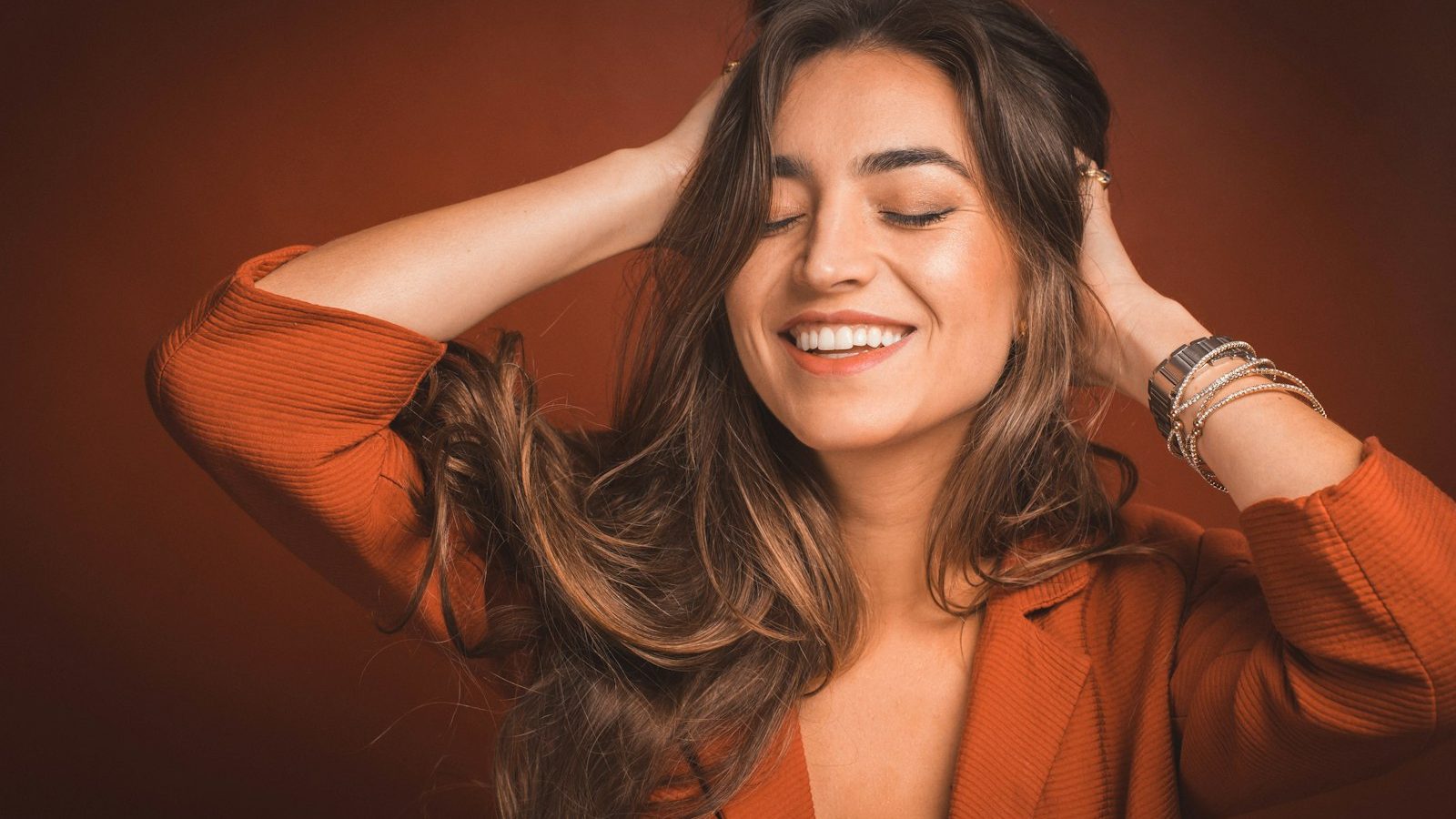 Keratin hair treatment: smiling woman with long glossy brown hair